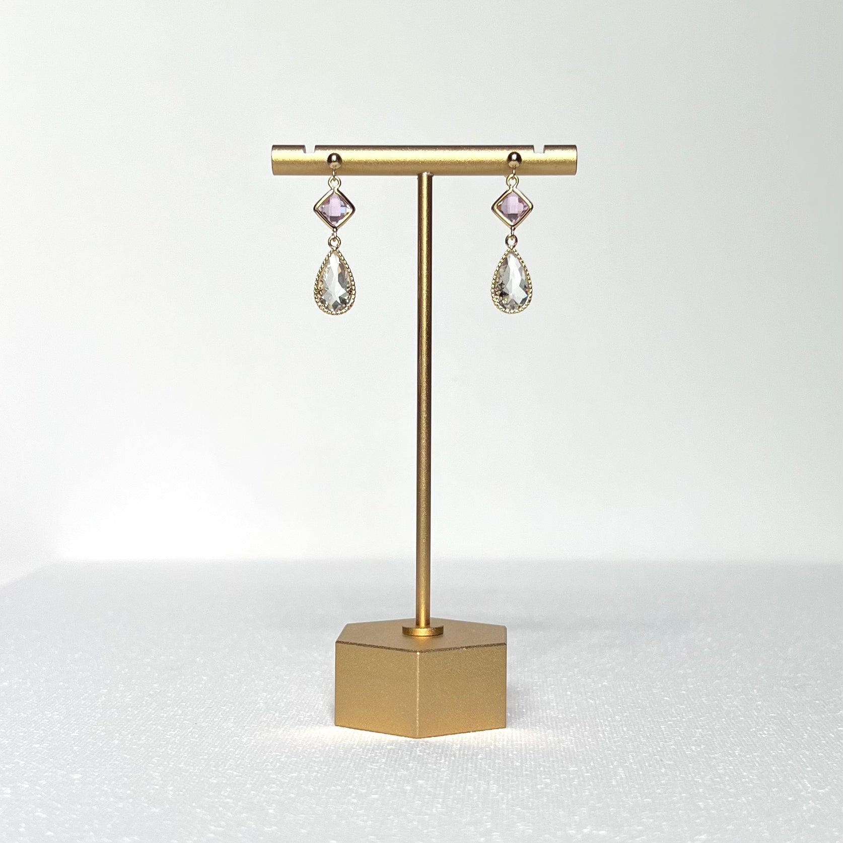 This earring set features a petite pink glass bezel set charm with a clear crystal teardrop shape fancy prong bezel setting hung on a 3mm gold filled earring stud post. 