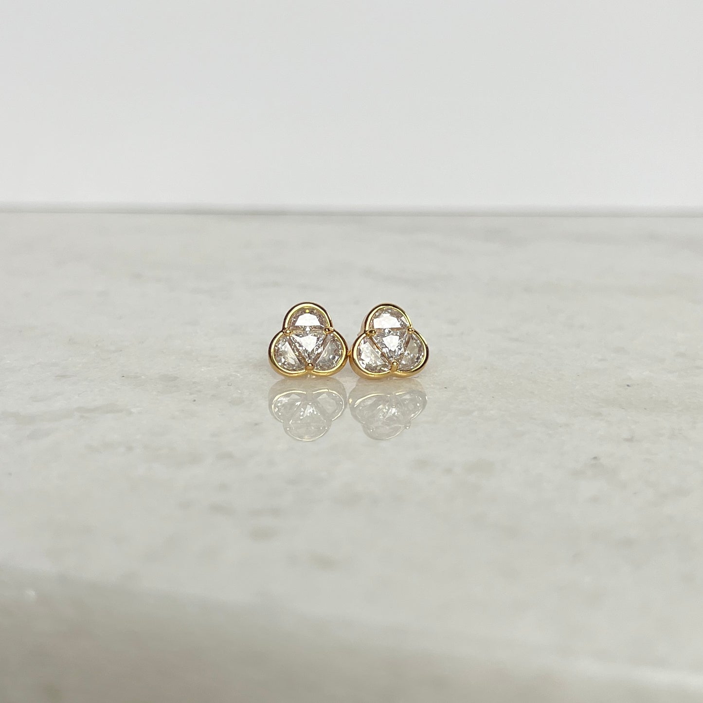 Three in one shaped triangular gold and cubic zirconia stud earrings, representing the Most Holy Trinity. 